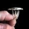 holding side view, large oval wild horse magnesite gemstone silver statement ring, bezel set with stamped cutout wire accent